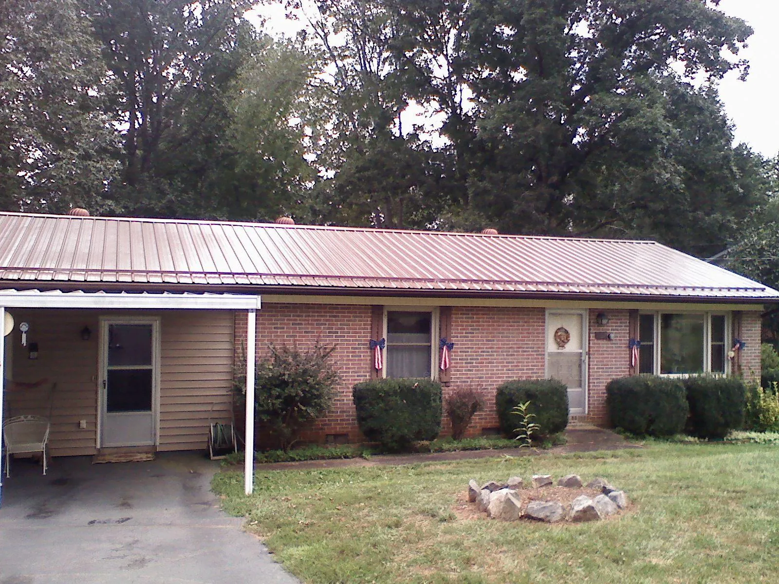 Bronze metal roof and carport on a brick ranch home — Roof Repair work by our crew in Wethersfield